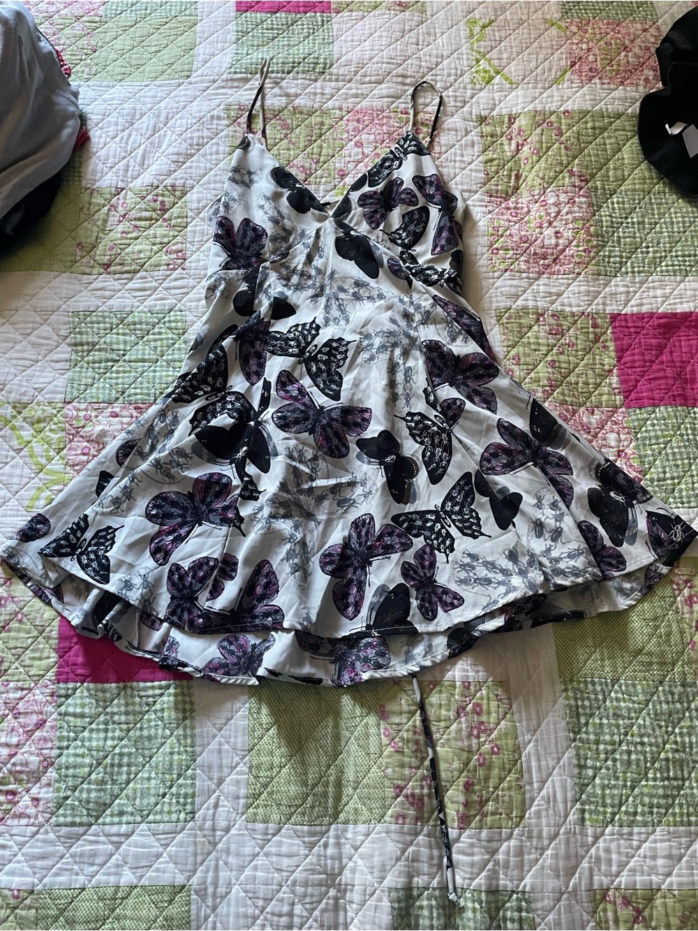 White woman’s Butterfly Print Spaghetti-Strap Dress with Purple Accents
